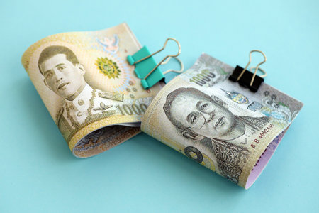 Thai baht money bills in big amount on blue close up. Finance and banking conceptの写真素材