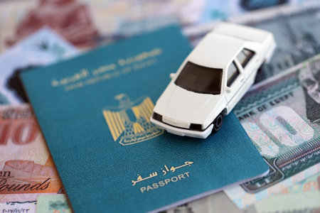 Egyptian pound currency money bills and car with passport close up. The concept of car ownershipの写真素材