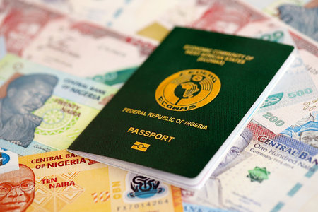 Nigerian naira currency money bills and passport close up. The concept of travel and vacation