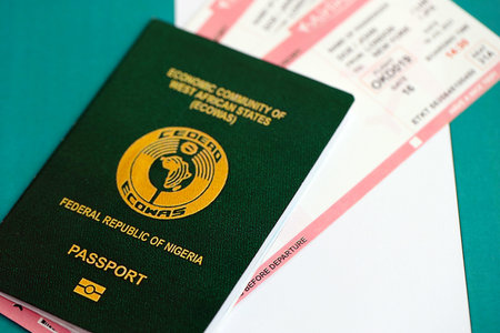 Nigerian passport and boarding pass tickets on flag close up. The concept of travel and vacationの写真素材