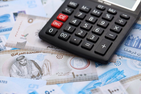 United Arab Emirates dirham currency money bills and calculator close up. The concept of taxation and money countの写真素材