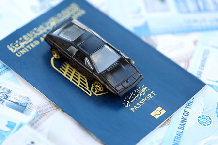 United Arab Emirates dirham currency money bills and car with passport close up. The concept of car ownershipの写真素材