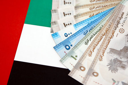 United Arab Emirates dirham currency money bills lies on flag close up. The concept of business and investmentの写真素材