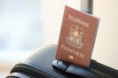 Philippines passport on travel luggage close up. The concept of travel and vacationの写真素材