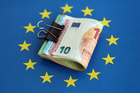 European euro currency money notes bunch on Europe union blue flag close up. Concept of business and economics in Europeの写真素材