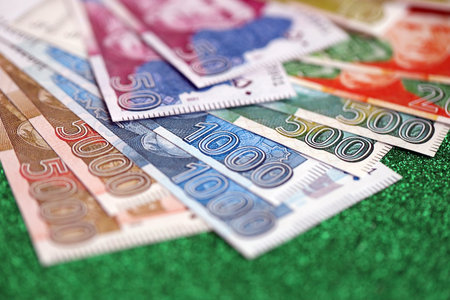 Pakistan rupees banknotes on glitter green background. The current Pakistan money bills lies on...