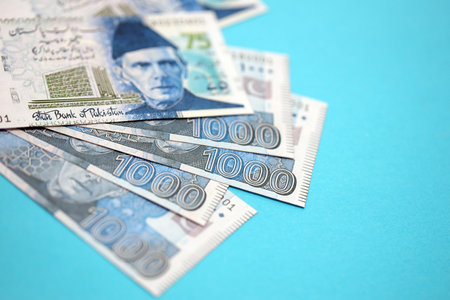 Pakistan rupees banknotes on blue background. The current Pakistan money bills lies on table in big amount. The concept of business and investment in Pakistanの写真素材