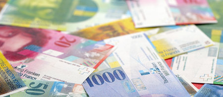 Swiss franc banknotes. The current francs money bills lies on table in big amount. The concept of business and investment in Switzerlandの写真素材