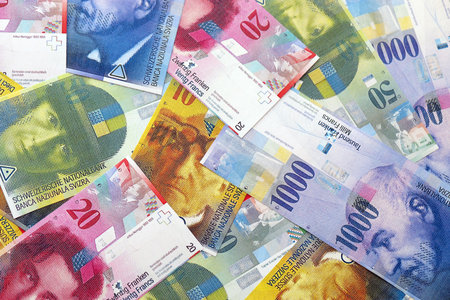 Swiss franc banknotes. The current francs money bills lies on table in big amount. The concept of business and investmentの写真素材