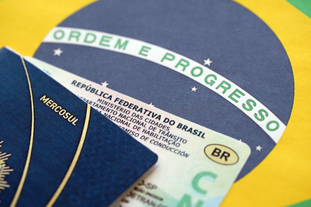 Brazil National Drivers License for a motor vehicle with passport on Brazilian flag close upの写真素材