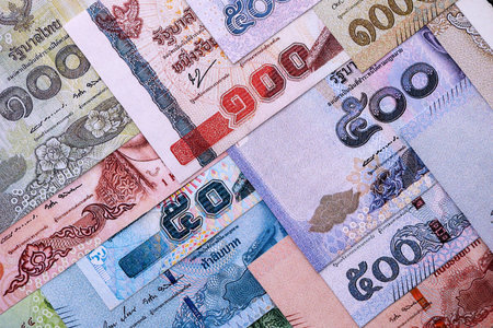Thai Baht currency money bills. THB currency banknotes in pile with different denomination close up