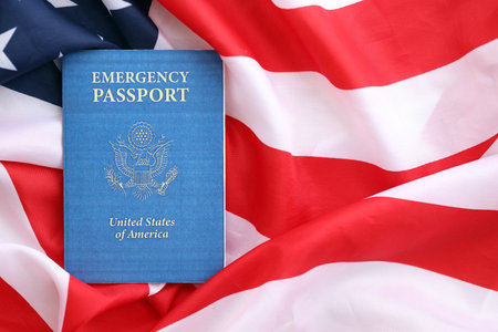 United States emergency passport book on US flag close up. Travel document on official banner photoの写真素材
