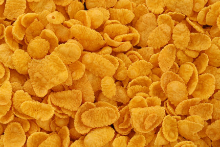 Corn flakes background and texture close up. Top view cornflake cereal for morning breakfast