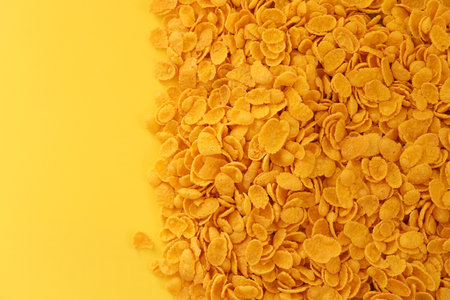 Background of breakfast cereals in big amount on yellow background close up, top viewの写真素材