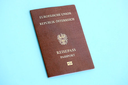 Austria passport on light blue paper background close up. Citizenship and travel in Europe conceptの写真素材