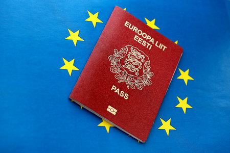 Estonia passport on European union blue flag background close up. Citizenship in countries of Europe conceptの写真素材