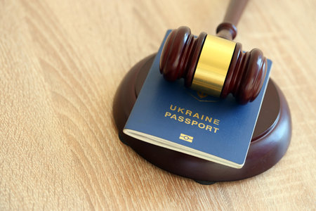 Judge hammer and ukrainian passport on brown background.の写真素材