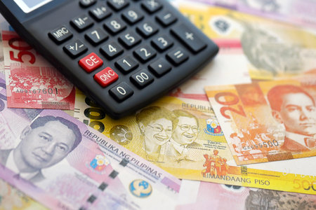 Philippines peso currency money bills and calculator close up. The concept of taxation and money countの写真素材