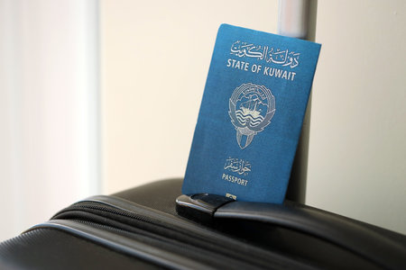 Kuwaiti passport on travel luggage close up. The concept of travel and vacationの写真素材