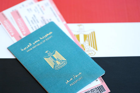 Egyptian passport and boarding pass tickets on flag close up. The concept of travel and vacation
