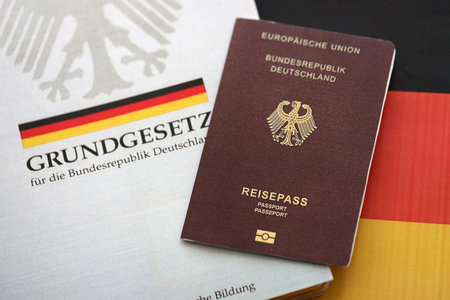 The constitution basic law book of Germany and passport lies on Germany flag background close upの写真素材
