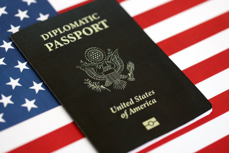 United States diplomatic passport book on US flag close up. Travel document on official banner photoの写真素材