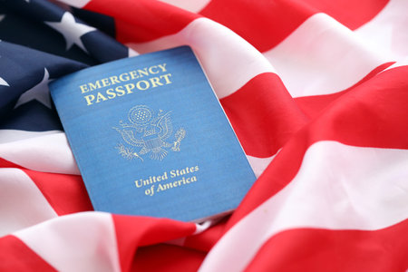 United States emergency passport book on US flag close up. Travel document on official banner photoの写真素材