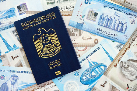 United Arab Emirates dirham currency money bills and passport close up. The concept of travel and...