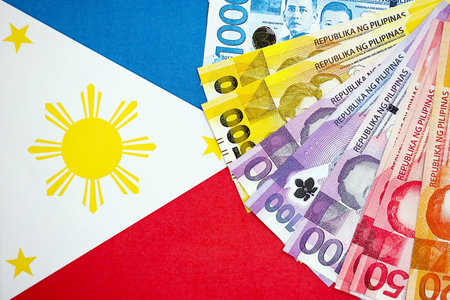 Philippines peso currency money bills lies on flag close up. The concept of business and investmentの写真素材