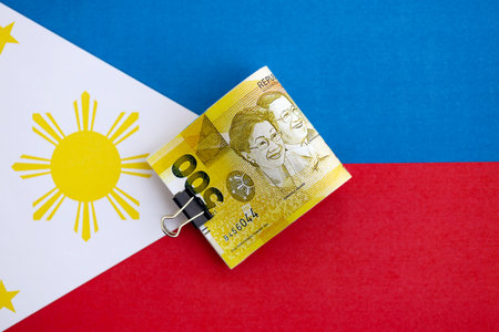 Philippines peso currency money bills lies on flag close up. The concept of business and investmentの写真素材