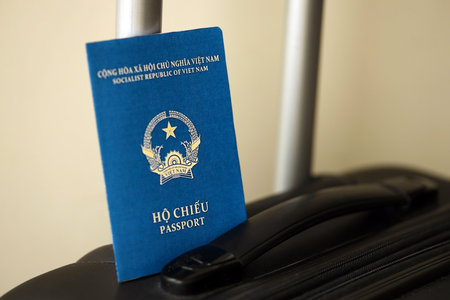 Vietnamese passport on travel luggage close up. The concept of travel and vacationの写真素材