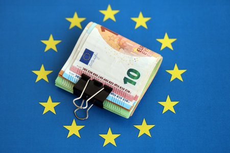 European euro currency money notes bunch on Europe union blue flag close up. Concept of business and economics in Europeの写真素材