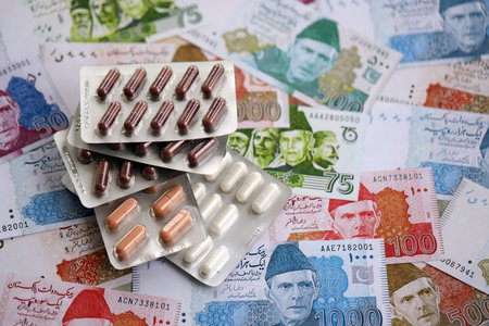 Pakistan rupees banknotes and medicine pills. The current Pakistan money bills and drugs lies on table in big amount. The concept of medicine and pharmacy in Pakistanの写真素材