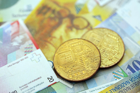 Swiss franc banknotes and bitcoin. The current francs money bills and bit coin lies on table in big amount. The concept of taxation and business in Switzerlandの写真素材