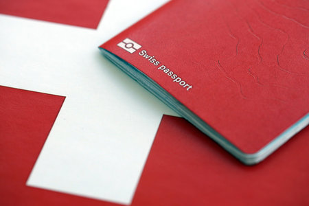 Swiss passport on flag. The current Swiss pass on flag close up. The concept of citizenship in Switzerlandの写真素材