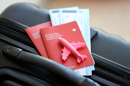Swiss passport and avia tickets on travel bag. Pass and boarding tokens on bag close up. The concept of travel and vacation in Switzerlandの写真素材