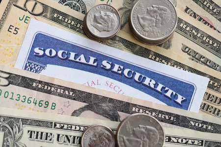 American US dollars money bills, social security number card and on American flag close up. Taxpaying and insurance conceptの写真素材