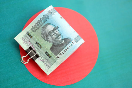 Bangladeshi taka money bills in big amount lies on Bangladesh flag close up. Finance and banking conceptの写真素材
