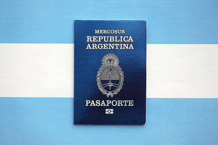 Argentine passport lies on Argentina flag close up. Travel and citizenship conceptの写真素材