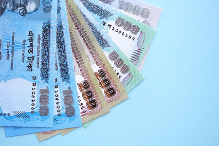 Bangladeshi taka money bills in big amount lies on teal color table close up. Finance and banking conceptの写真素材