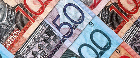 Dominican Republic Pesos currency money bills. DOP currency banknotes in stack with different...