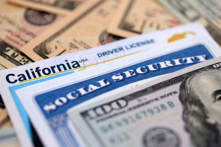 Social security number and California driving license with US dollar money bills close up