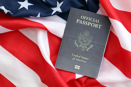 United States official passport book on US flag close up. Travel document on official banner photoの写真素材
