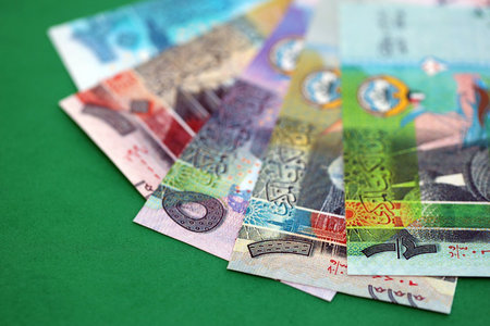 Kuwaiti dinar money bills in big amount on green close up. Finance and banking concept