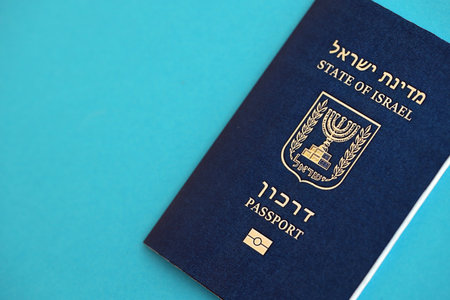 Israel passport on blue. The current Israel biometrical pass lies on blue background close up. The concept of citizenship in Israelの写真素材