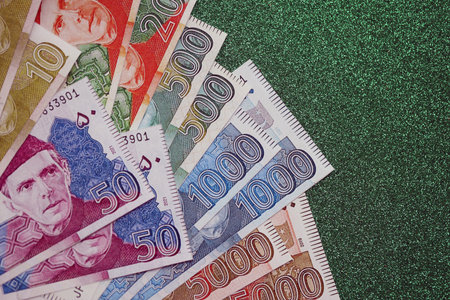 Pakistan rupees banknotes on glitter green background. The current Pakistan money bills lies on table in big amount. The concept of business and investment in Pakistanの写真素材