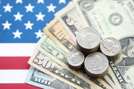American US dollars money bills and on American flag close up. Money investment concept and...