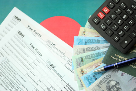 Bangladeshi taka money bills in big amount lies on table with pen, calculator, passport and tax forms close up. Finance and banking conceptの写真素材