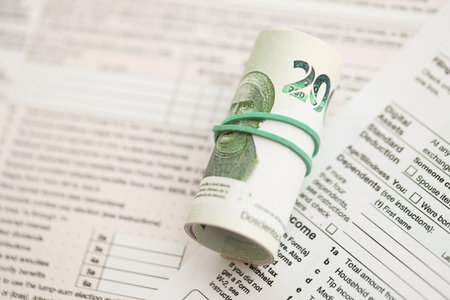 Mexican pesos money bills in big amount lies on table with tax forms close up. Accounting and taxation conceptの写真素材