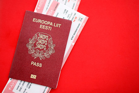 Estonia passport and commercial airlines boarding pass tickets close up. Travel flights and avia tourism in Europe conceptの写真素材